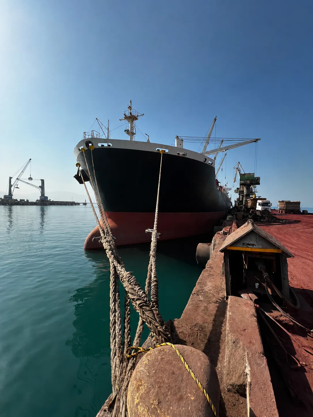 Bulk carrier alongside a quay with dockside cranes