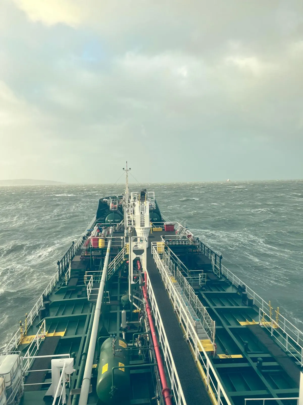 Tanker deck piping and machinery, underway in rough seas